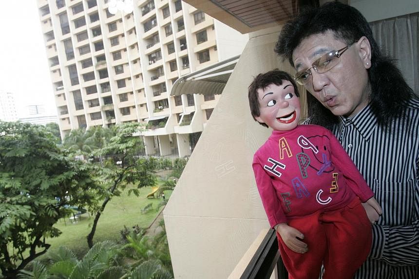 Victor Khoo and his ventriloqist dummy Charlee.&nbsp;Khoo died on Friday morning after a battle with cancer. -- PHOTO: ST FILE