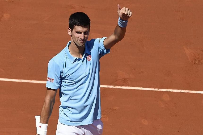 Serbia's Novak Djokovic celebrates after winning his French Open semi-final match against Latvia's Ernests Gulbis at the Roland Garros stadium in Paris on June 6, 2014. -- PHOTO: AFP&nbsp;