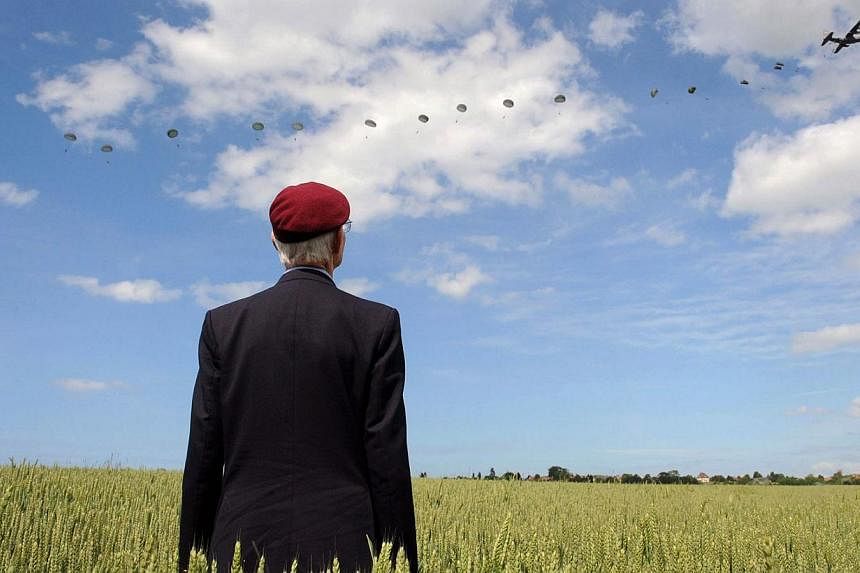 British World War II veteran Frederick Glover watches as soldiers parachute down during a D-Day commemoration paratroopers launch event in Ranville, northern France, on June 5, 2014. -- PHOTO: REUTERS&nbsp;