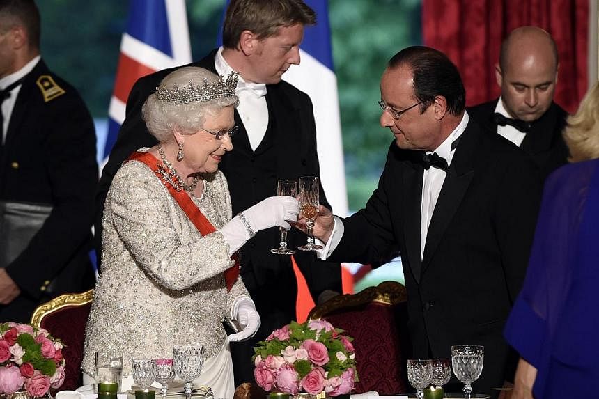 Britain's Queen Elizabeth II toasts with French President Francois Hollande at a state dinner at the Elysee presidential palace in Paris, following the international D-Day commemoration ceremonies in Normandy, marking the 70th anniversary of the Worl