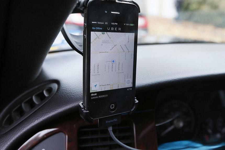 Transportation app Uber is seen on the iPhone of a limousine driver in Beverly Hills, California on Dec 19, 2013. -- PHOTO: REUTERS