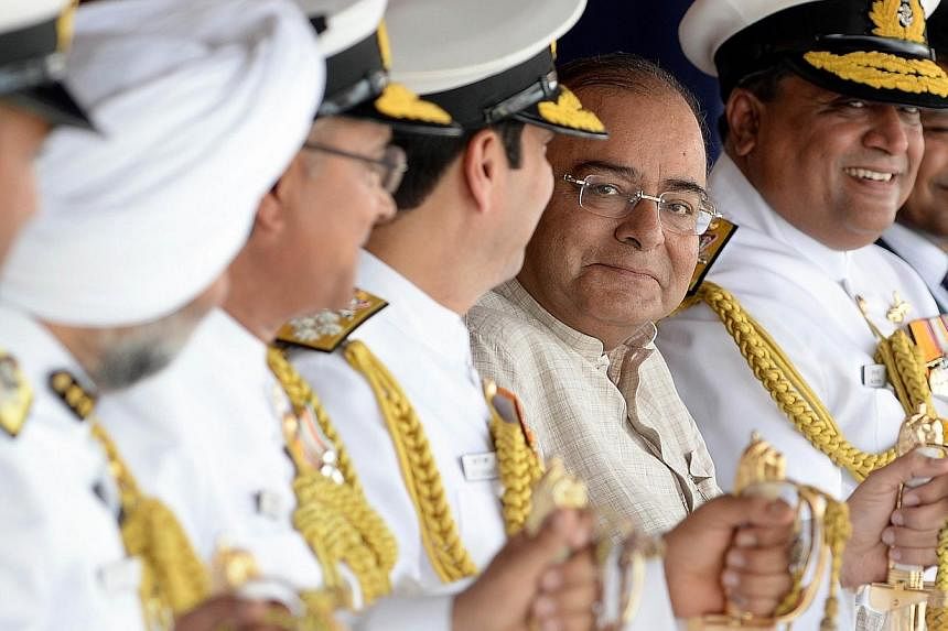 India's new Finance Minister and Defence Minister Arun Jaitley (C) attends the commissioning ceremony of the two Indian Coast Guard ships 'Achook' and 'Agrim' at naval dockyard in Mumbai June 7, 2014. --PHOTO: REUTERS