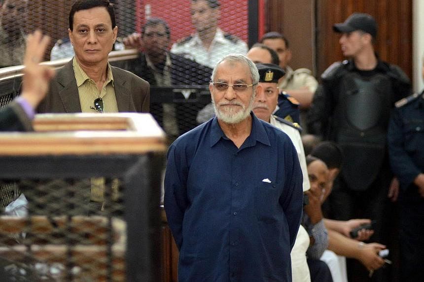 Egyptian Brotherhood's supreme guide Mohamed Badie (C) stands in front of his judges during his trial in the capital Cairo on May 18, 2014.&nbsp;An Egyptian court on Saturday postponed to July 5, the verdict in the trial of Muslim Brotherhood leader 