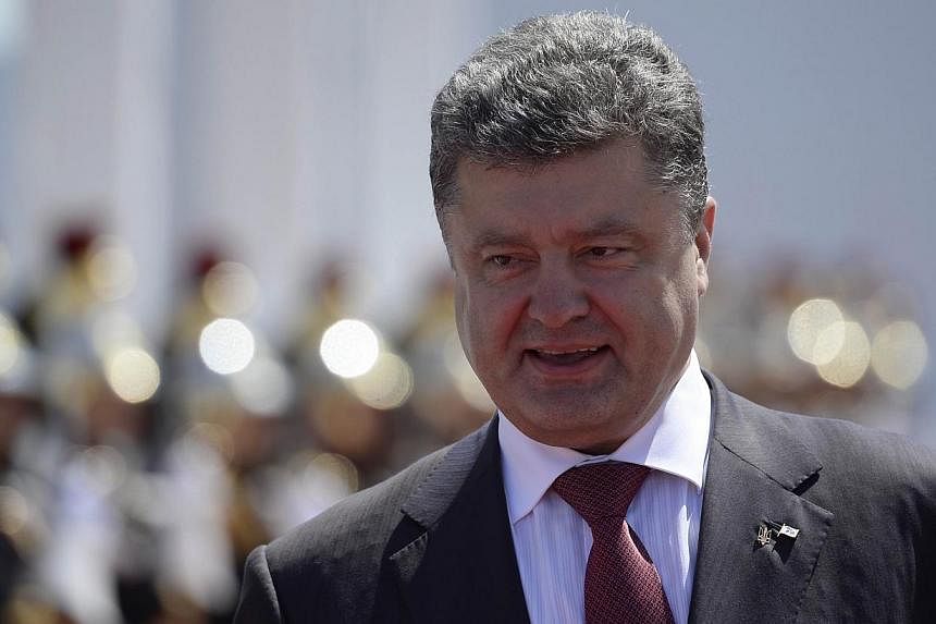 Mr Poroshenko was sworn in as president of his troubled country on Saturday as government forces battled pro-Russian separatists in the east. -- PHOTO: AFP