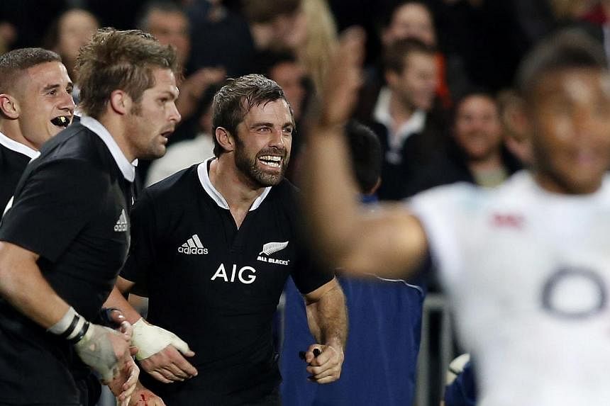 New Zealand All Blacks' Conrad Smith (third, left) celebrates scoring a try with captain Richie McCaw (second, left) during their first rugby union test match against England at Eden Park in Auckland on June 7, 2014.&nbsp;-- PHOTO: REUTERS