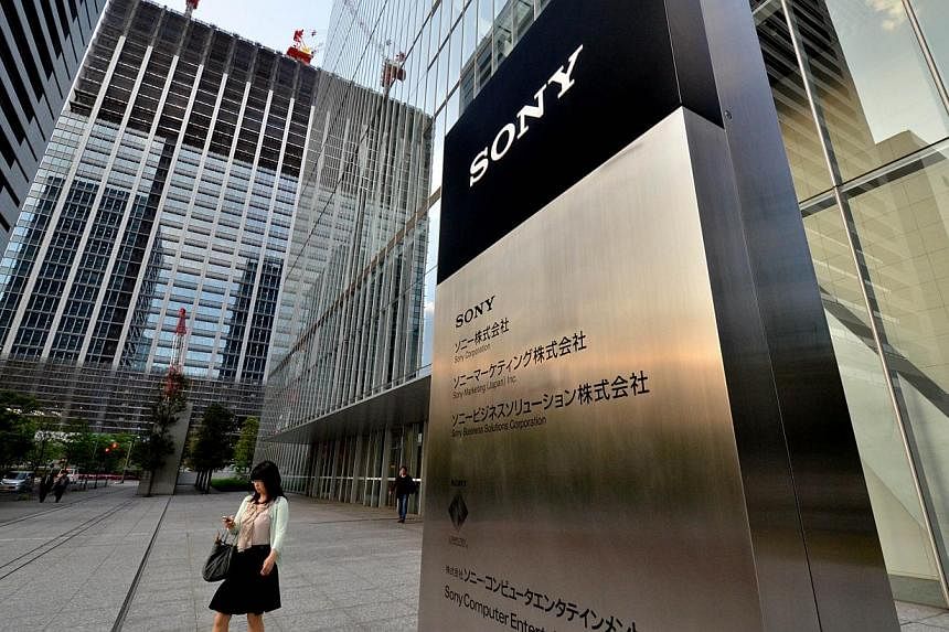 A woman passes before Sony's headquarters in Tokyo on May 1, 2014.&nbsp;-- PHOTO: AFP