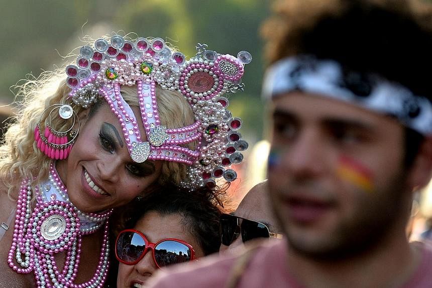 Tens of thousands took to the streets of Rome on Saturday for the city's annual Gay Pride parade and to call on the Italian government to recognise civil unions for same-sex couples. -- PHOTO: AFP