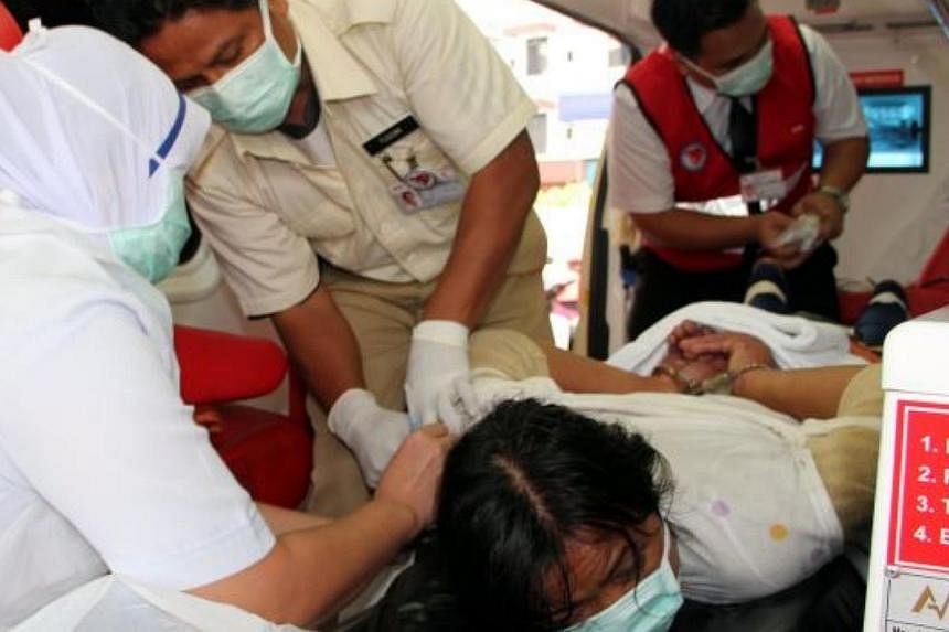 The maid being restrained before being taken to the Sibu Hospital. -- PHOTO: THE STAR/ASIA NEWS NETWORK&nbsp;