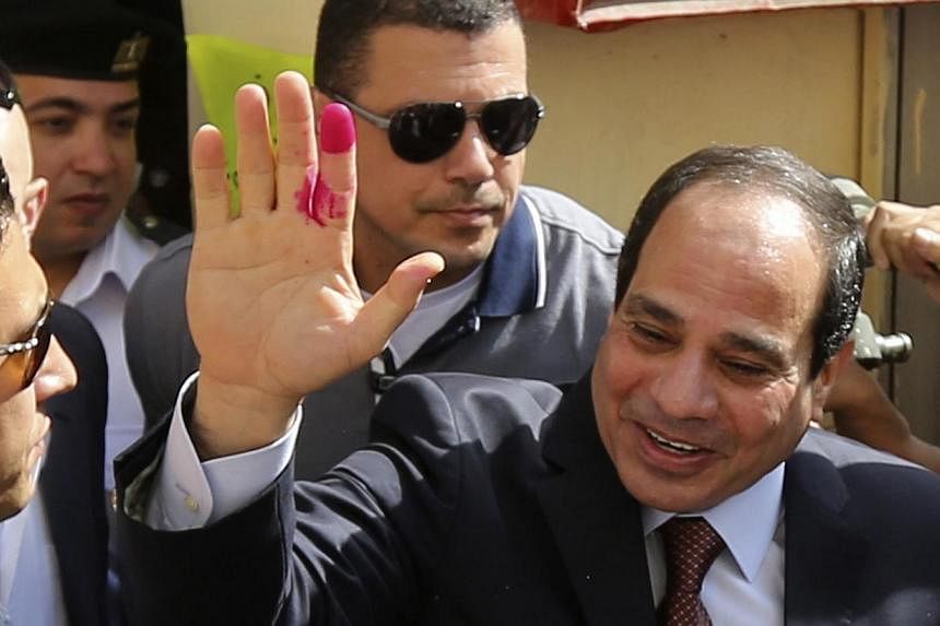 Egypt's new president and former army chief Abdel Fattah al-Sisi gestures after casting his ballot in Cairo, May 26, 2014. -- PHOTO: AFP