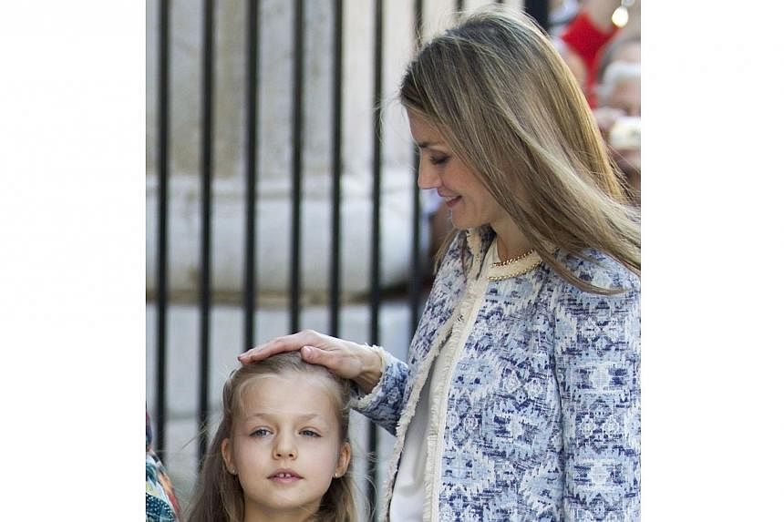 Spain's Princess Letizia (right) and her daughter Leonor at Palma de Mallorca's cathedral after the traditional Mass of Resurrection on March 31, 2013. -- FILE PHOTO: AFP
