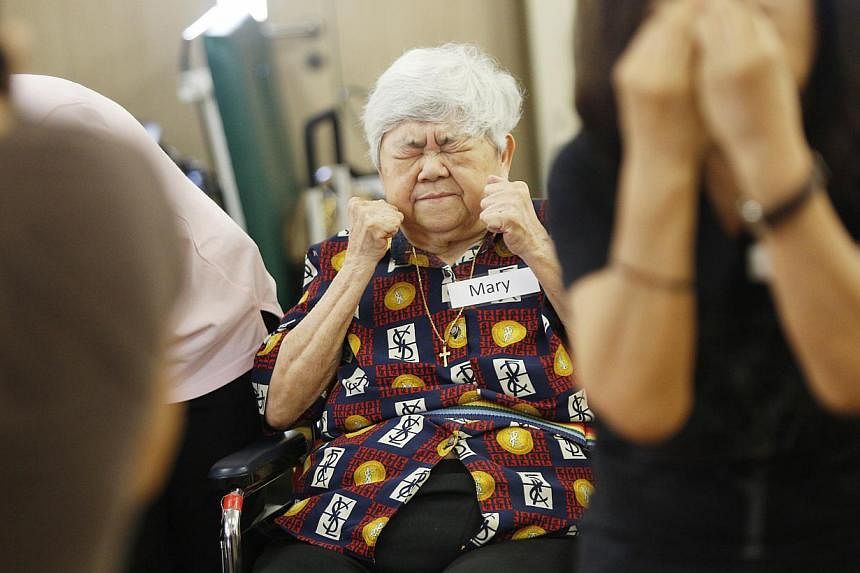 Madam Mary Tan (left), 80, and other residents at the Villa Francis Home for the Aged taking part in dance therapy sessions led by trainers from the Arts Fission Company (right) under an AIC pilot project.
