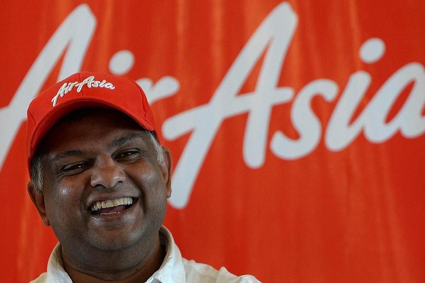 In this photograph taken on July 1, 2013, AirAsia's chief executive Tony Fernandes laughs during a press conference in Mumbai. Asia's biggest budget carrier AirAsia is set to make its maiden Indian flight this week, fuelling a cut-throat fare war in 