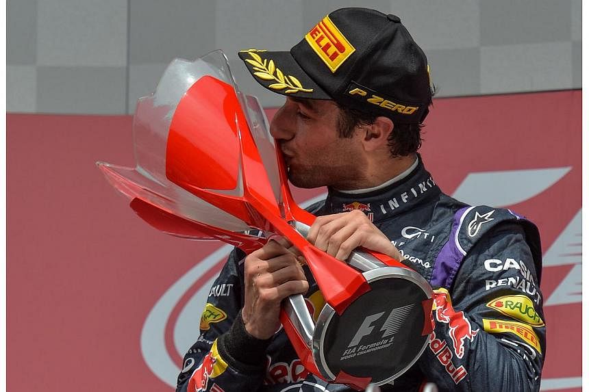 Red Bull Racing's Australian driver Daniel Ricciardo kisses the trophy after winning the Canadian Formula One Grand Prix at the Circuit Gilles Villeneuve in Montreal on June 8, 2014. -- PHOTO: AFP