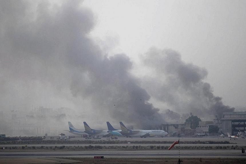 Smoke rises after militants launched an early morning assault at Jinnah International Airport in Karachi on June 9, 2014. Pakistan's security forces said on June 9 they have relaunched a military operation at Karachi airport as gunfire resumed severa