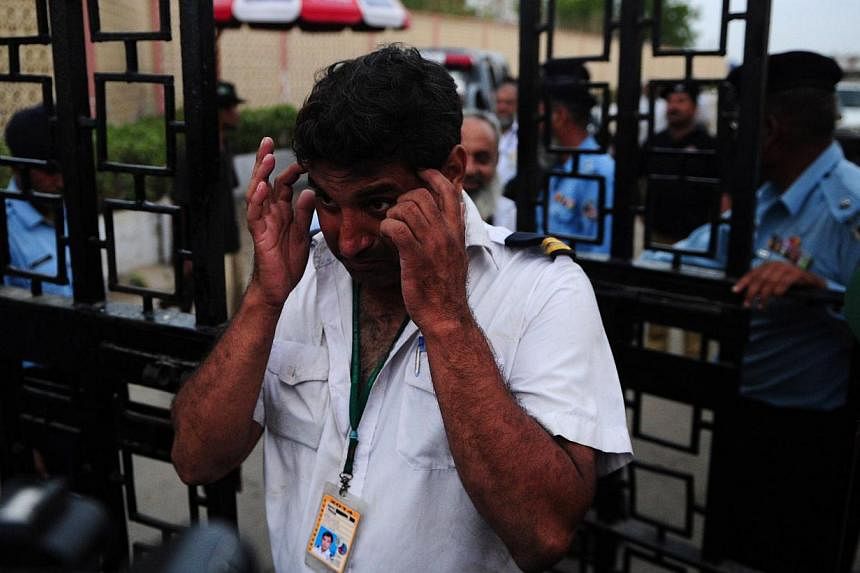 Pakistani airport employees leave the Jinnah International Airport after militants attack in Karachi on June 9, 2014. -- PHOTO: AFP