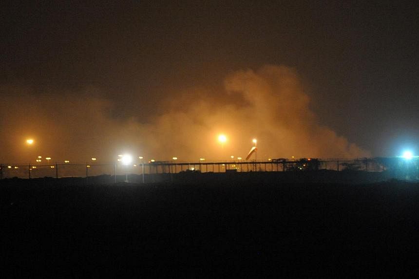 Smoke rises from the Karachi airport terminal after the militants' assault in Karachi on June 9, 2014. -- PHOTO: AFP