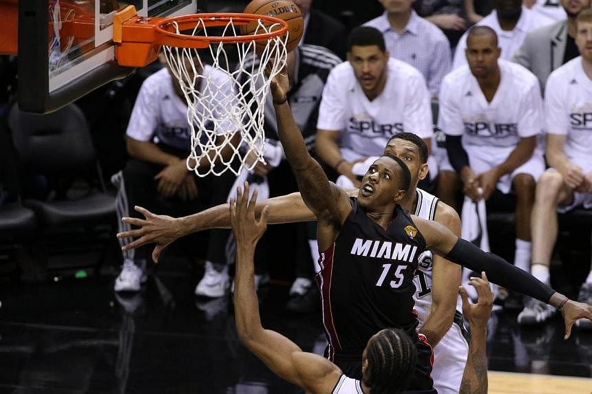 Miami Heat guard Mario Chalmers (15) shoots against the San Antonio Spurs in game two of the 2014 NBA Finals at AT&amp;T Center. -- PHOTO: REUTERS/USA TODAY SPORTS