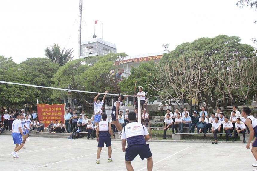 Vietnamese naval servicemen and Filipino naval servicemen play volleyball during a friendly match on Vietnam-held Song Tu Tay or Southwest Cay island of the disputed Spratly Islands on South China Sea on June 8, 2014.&nbsp;China denounced Vietnam and