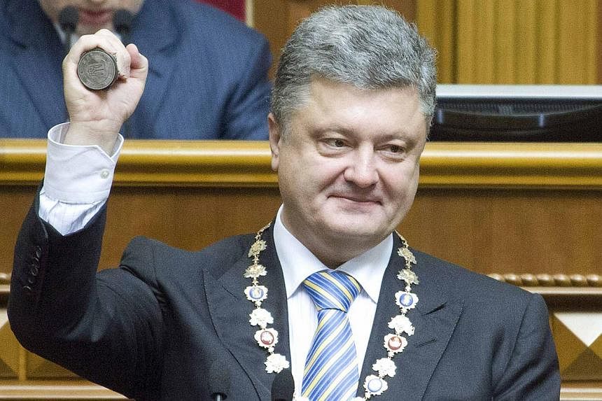 Ukraine's President-elect Petro Poroshenko shows the presidential seal during his inauguration ceremony in the parliament hall in Kiev on June 7, 2014. -- PHOTO: REUTERS