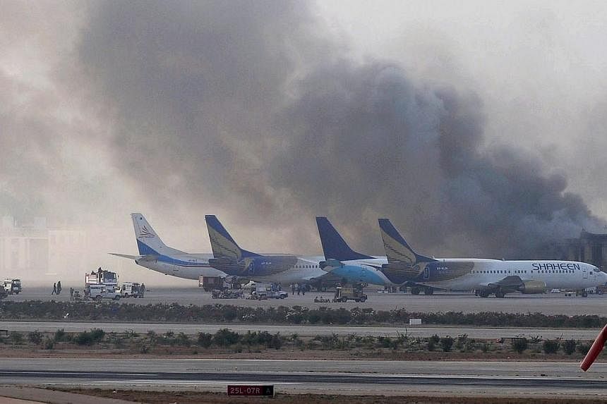Smoke rises after militants launched an early morning assault at Jinnah International Airport in Karachi on June 9, 2014.&nbsp;Their backpacks stuffed with food and ammunition, a squad of highly trained Taleban fighters attacked Pakistan's biggest ai