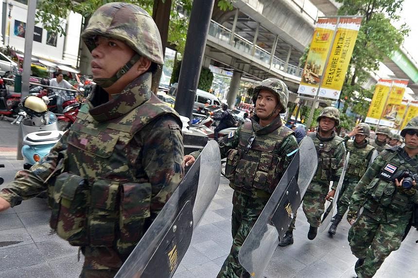 Thai soldiers on patrol at Ratchaprasong intersection in Bangkok on June 1, 2014.&nbsp;Thailand's junta said on Monday, June 9, 2014, that it had ordered the Thai ambassadors to the United States and Britain to meet human rights groups in an effort t