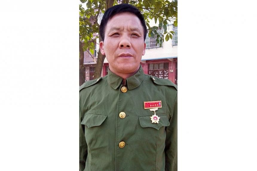 This undated mobile phone picture shows former Chinese Vietnam veteran soldier Teng Xingqiu in military uniform. Marginalised and misunderstood, Chinese Vietnam veterans -- who fought in a little-celebrated war with its southern neighbour -- risk bea