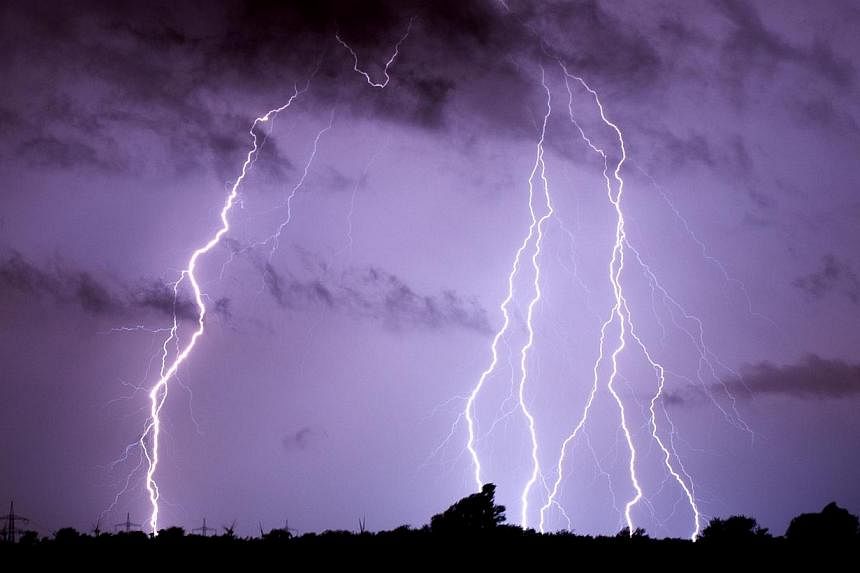 Lightning is pictured on June 10, 2014 over Algermissen, Germany. -- PHOTO: AFP