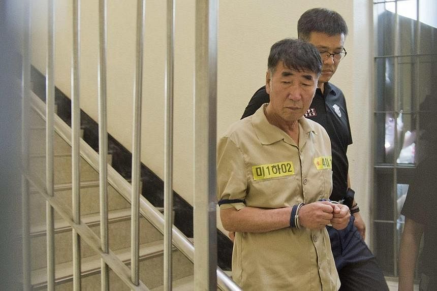 Lee Joon Seok, captain of sunken ferry Sewol, arrives at a court in Gwangju on June 10, 2014.&nbsp;Fifteen crew members of a South Korean ferry that sank in April killing more than 300 people, most of them children, went on trial on Tuesday, June 10,