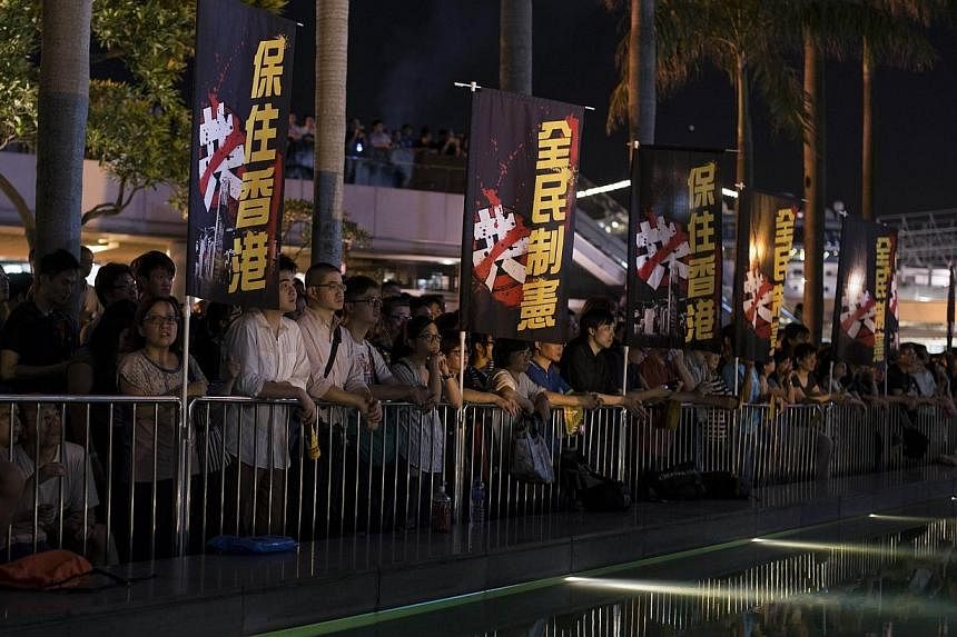 Pro-democracy activists hold a rally to mark the 1989 Tiananmen Square military crackdown, in the Tsim Sha Tsui area of Hong Kong on June 4, 2014.&nbsp;China warned Hong Kong on Tuesday, June 10, 2014, that there were limits to its freedom and it sho