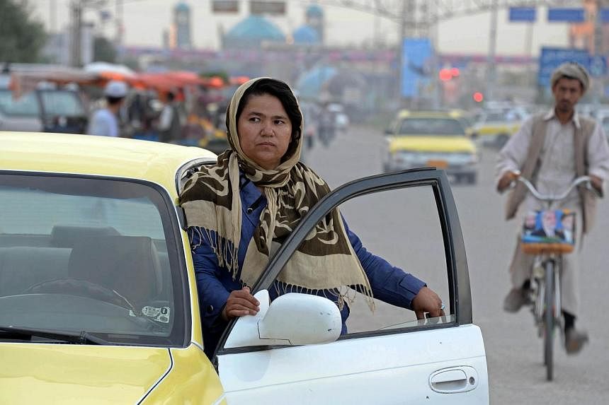 When Afghan taxi driver Sara Bahai has male passengers in her cab, she takes the chance to lobby them on female rights - and she hopes the country's next president will also listen to her arguments. -- PHOTO: AFP