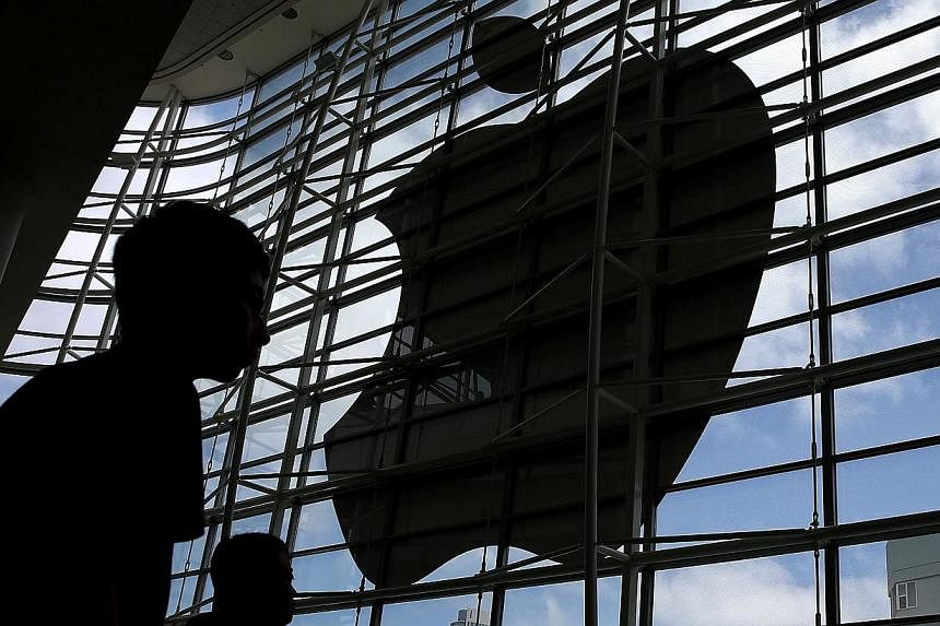 Apple shares swung higher on Monday as investors remained upbeat on the US tech giant in the first day of trading after a 7-for-1 stock split. -- PHOTO: AFP&nbsp;