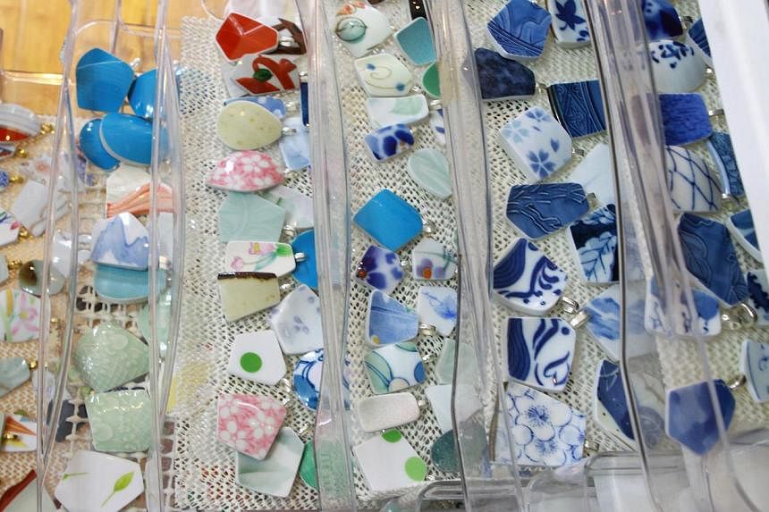 Pieces of broken pottery that were picked up by a team of volunteers. The pieces are washed and then cut down to size to be used to make jewellery.&nbsp;After the shards are polished, they are separated based on their shape, size and colour (above). 