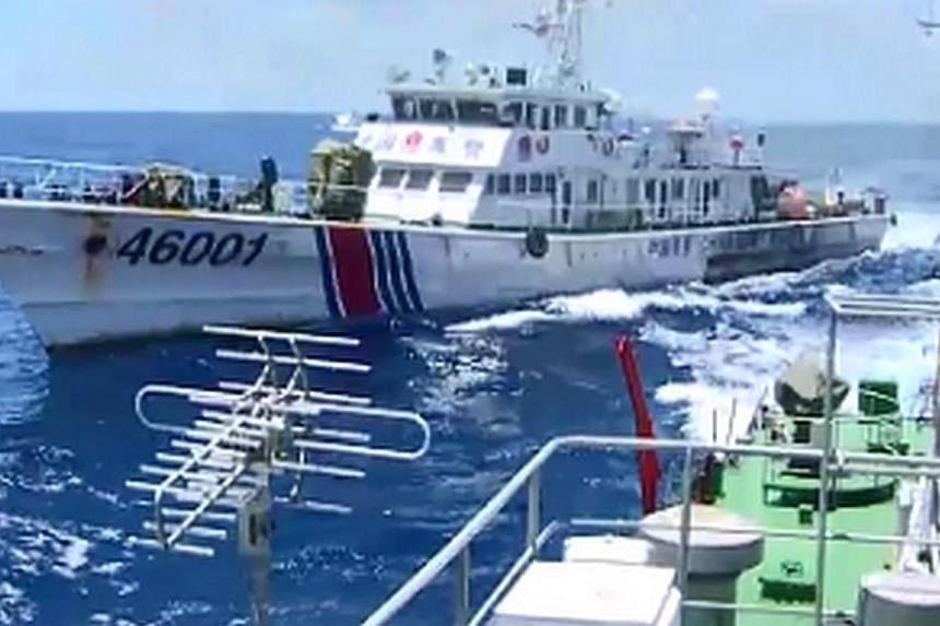 This video grab image taken on June 1, 2014 from Vietnam Coast Guard ship 2016 and released on June 5, 2014 shows the Chinese Coast Guard ship 46001 (L) chasing a Vietnamese vessel near to the site of the Chinese oil rig in disputed waters in the Sou
