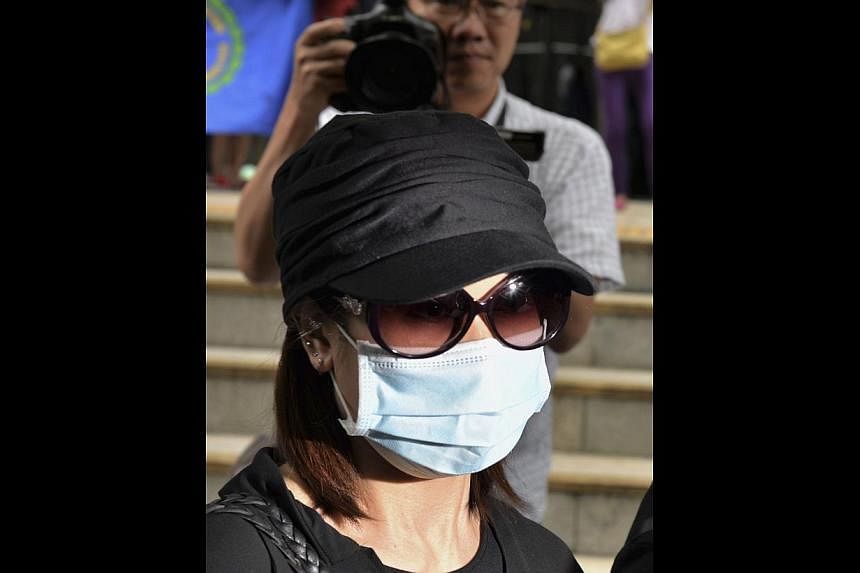 Former beautician Law Wan-tung, 44, leaving a district court in Hong Kong on June 10, 2014. The Hong Kong woman pleaded not guilty on Tuesday to 20 charges of abusing her Indonesian domestic helper in a landmark case, with pictures of her bruised bod