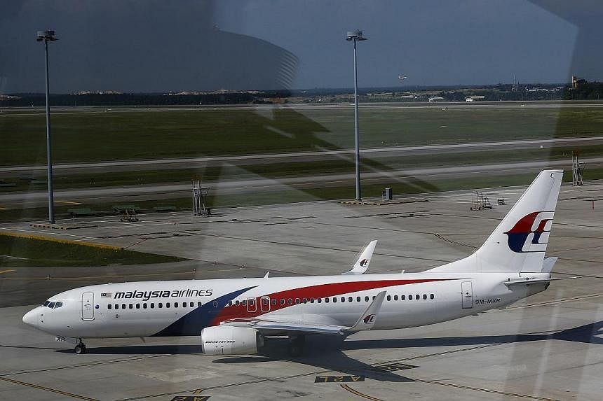 A Malaysia Airlines Boeing 737-800 aircraft is seen on tarmac of Kuala Lumpur International Airport in Sepang on May 21, 2014. -- PHOTO: REUTERS