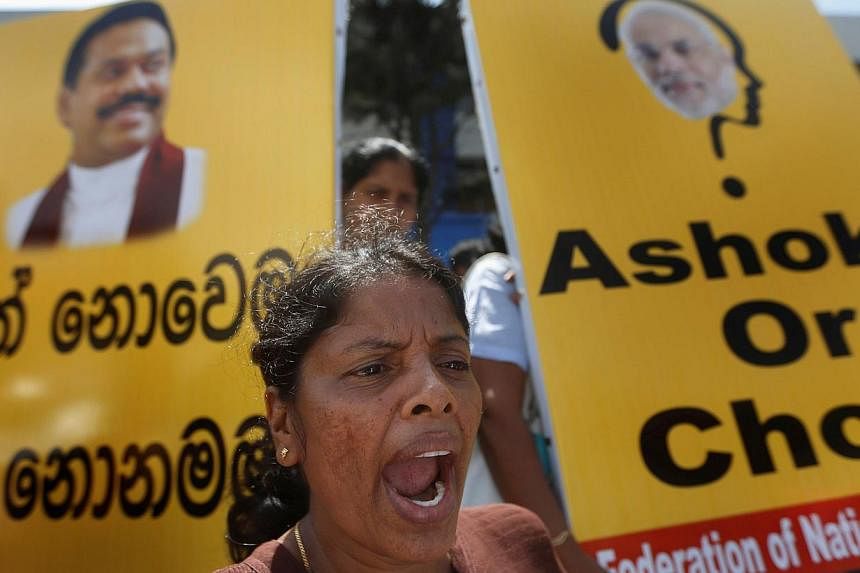 A demonstrator from the Freedom of National Organization shouts slogans against Indian Prime Minister Narendra Modi, outside the Indian High Commission to Sri Lanka, in Colombo on June 10, 2014.&nbsp;Hundreds of activists protested in the Sri Lankan 