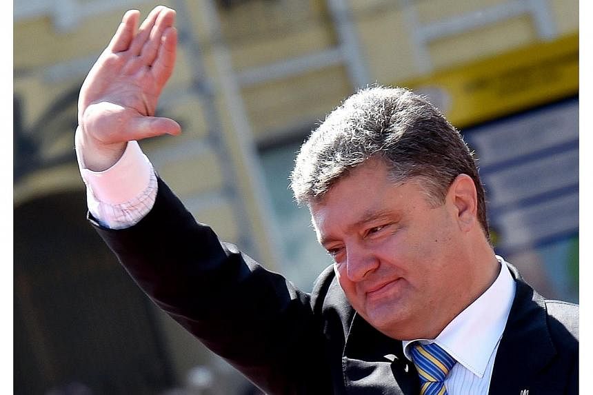 The meetings in Brussels and Kiev are the first challenges for new Ukrainian President Petro Poroshenko (above) who has vowed dialogue with Moscow to try to prevent the bitterly divided former Soviet state from splitting. -- PHOTO: AFP