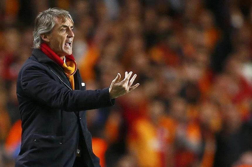 Galatasaray's coach Roberto Mancini gestures during their Champions League soccer match against Chelsea at Stamford Bridge in London March 18, 2014. Mancini has left Turkish giants Galatasaray by mutual consent after one season, the club announced on
