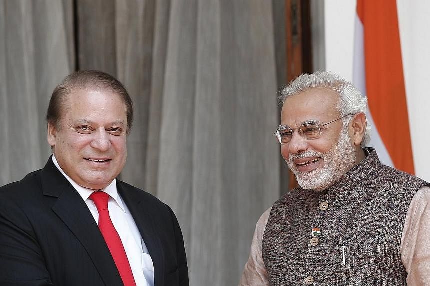 India's Prime Minister Narendra Modi (right) and his Pakistani counterpart Nawaz Sharif smile before the start of their bilateral meeting in New Delhi May 27, 2014.&nbsp;Mr Sharif has written to his new Indian counterpart to express satisfaction with