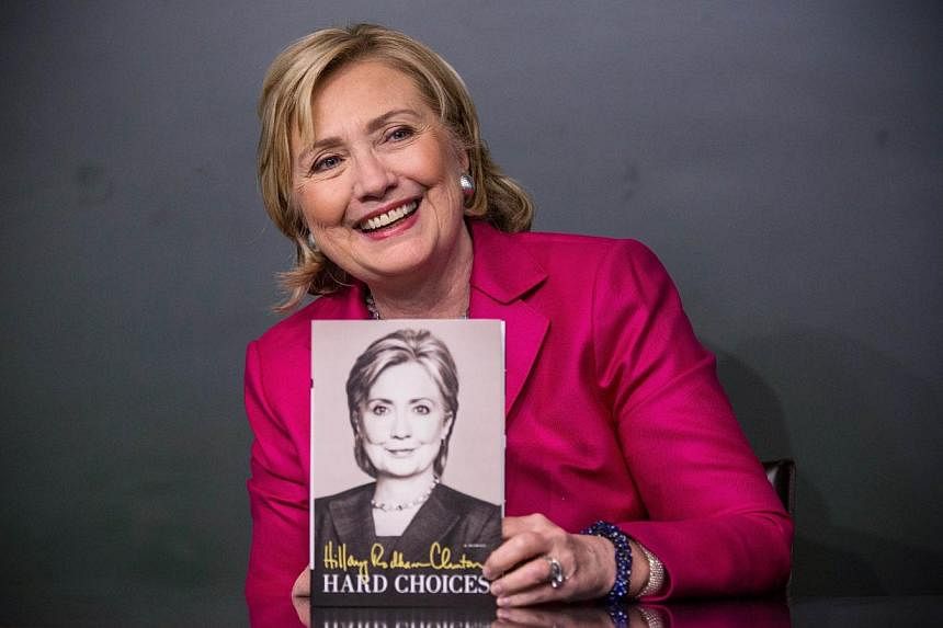 Former Secretary of State Hillary Clinton poses with her new book, "Hard Choices" during a book signing at a Barnes &amp; Noble&nbsp;in New York City&nbsp;on June 10, 2014. -- PHOTO: AFP