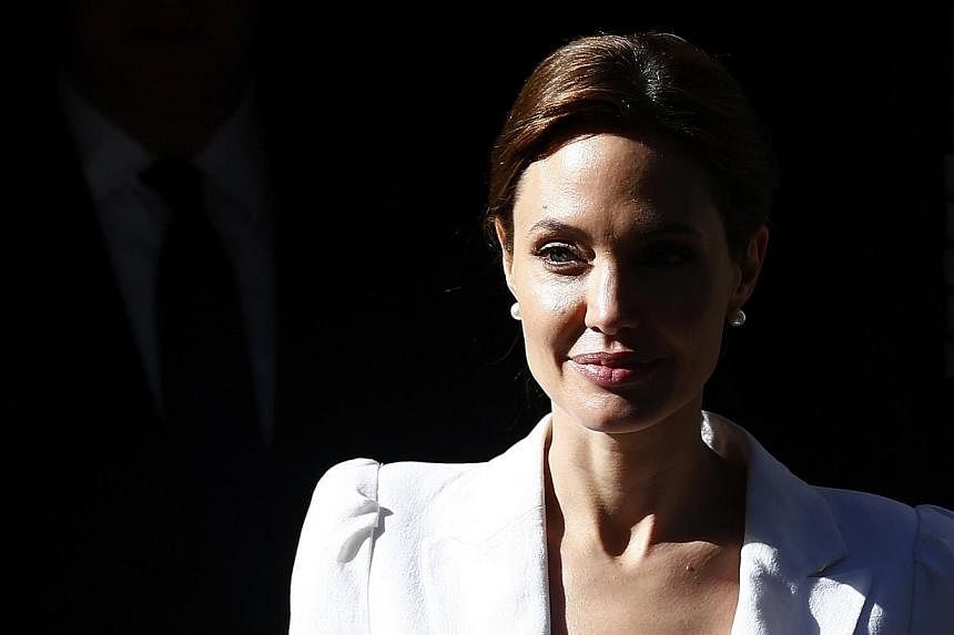 Actress and campaigner Angelina Jolie leaves 10 Downing Street after meeting Britain's Prime Minister David Cameron in London June 10, 2014. -- PHOTO: REUTERS