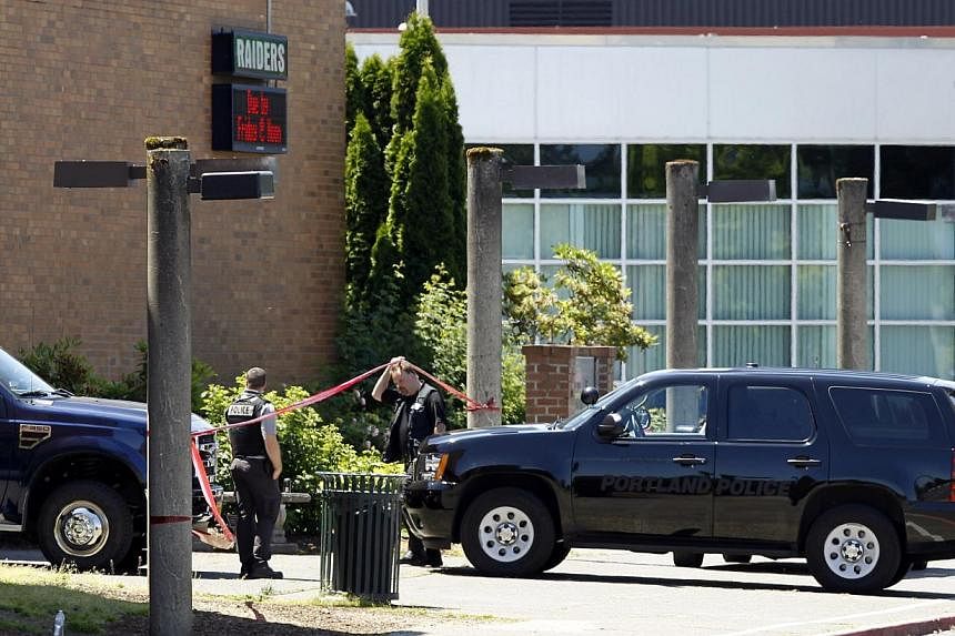 Police officers enter the building after a shooting at Reynolds High School in Troutdale, Oregon on June 10, 2014. -- PHOTO: REUTERS