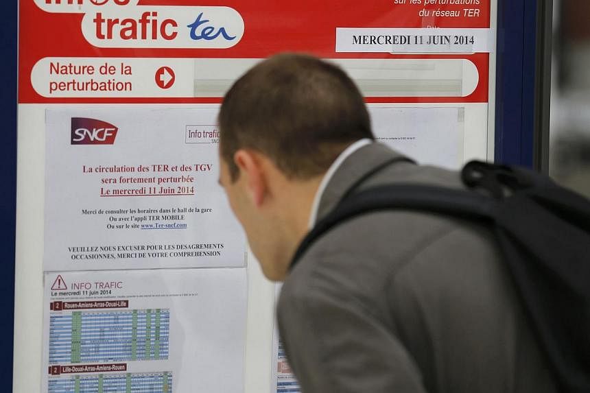 A commuter looks at an information board at the Lille-Flandres station, northern France, June 10, 2014, before the start of a strike by French SNCF railway workers.&nbsp;French commuters faced travel chaos on Wednesday with a major train strike again