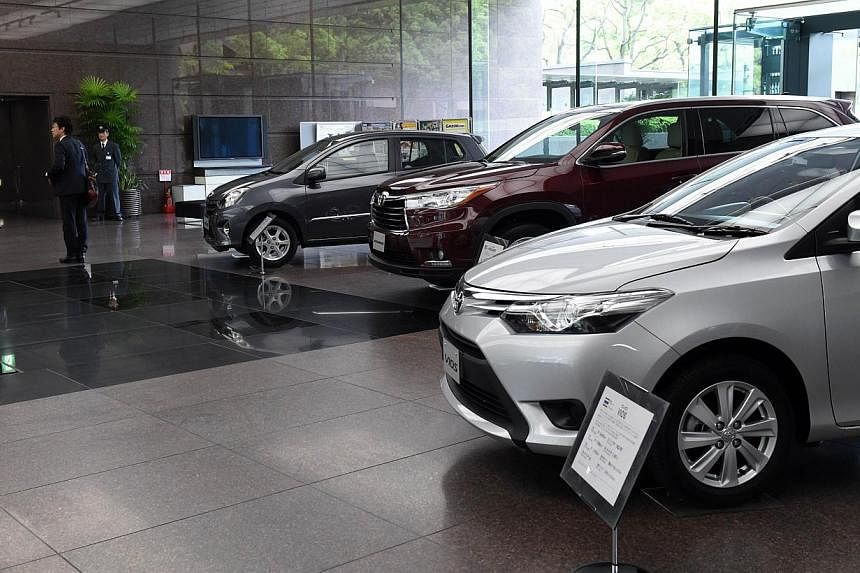 Vehicles are displayed at Toyota Motors' Tokyo headquarters on May 8, 2014. -- PHOTO: AFP