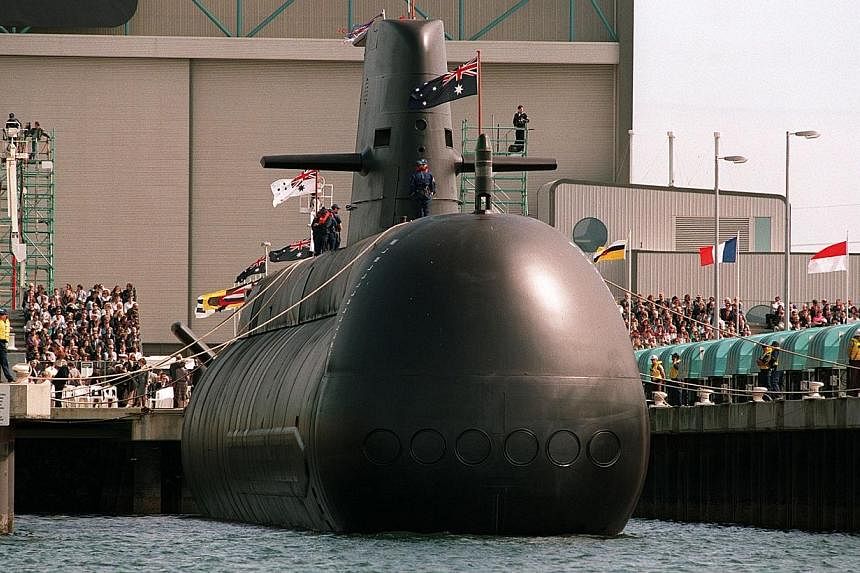 This file photo taken on August 28, 1993 shows the first high-tech Collins-class submarine being lowered into the water at Port Adelaide.&nbsp;Australia on Thursday backed Prime Minister Shinzo Abe's drive to expand the use of Japan's military, haili
