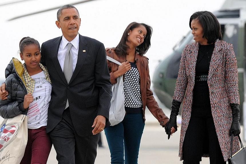 In this November 7, 2012 file photo US President Barack Obama, First Lady Michelle Obama and their daughters Malia and Sasha(left) borad Air Force One at Chicago O'Hare International Airport in Chicago.&nbsp;US President Barack Obama says he is a "go