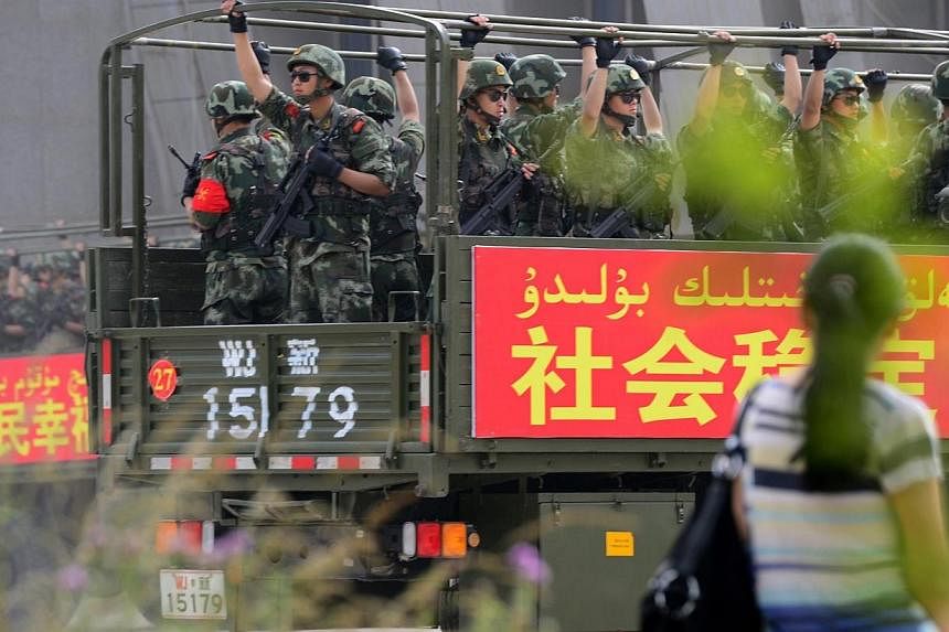 This picture taken on June 6, 2014 shows security forces participating in a military drill in Hetian, northwest China's Xinjiang region.&nbsp;An extremist minority that rejects the Chinese Communist Party's "care" is to blame for rising violence stem