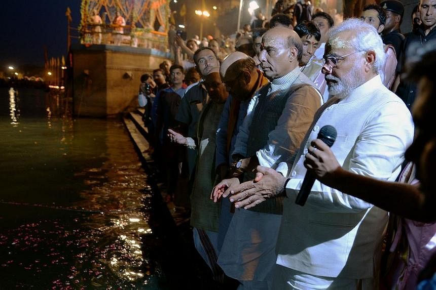 Indian Prime Minister Narendra Modi (right) performs the "Ganga Puja" religious ritual with Bharatiya Janata Party (BJP) President Rajnath Singh (second right) and other senior BJP leaders on the banks of the River Ganges.&nbsp;India's new government