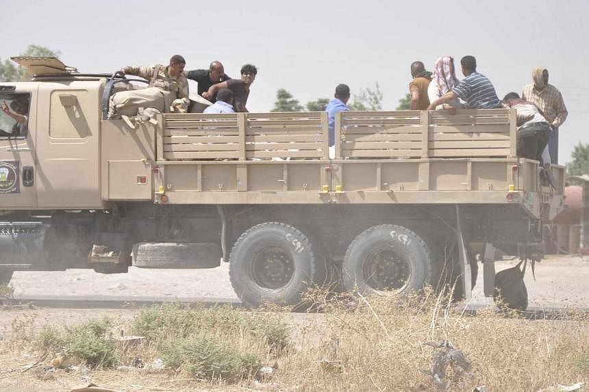 Iraqi security forces leave a military base as Kurdish forces take over control in Kirkuk on June 11, 2014. -- PHOTO: REUTERS