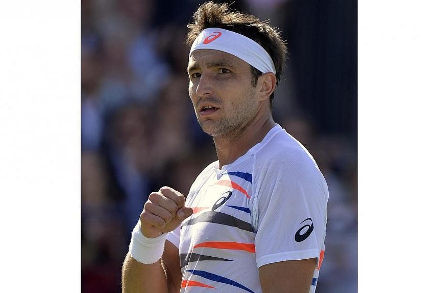 Australia's Marinko Matosevic celebrates defeating Croatia's Marin Cilic in their men's singles tennis match at the Queen's Club Championships tennis tournament in west London, on June 10, 2014. -- PHOTO: REUTERS